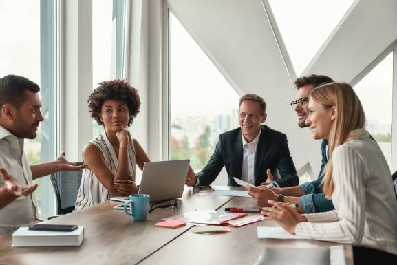 Business people sitting around at a table having a meeting.